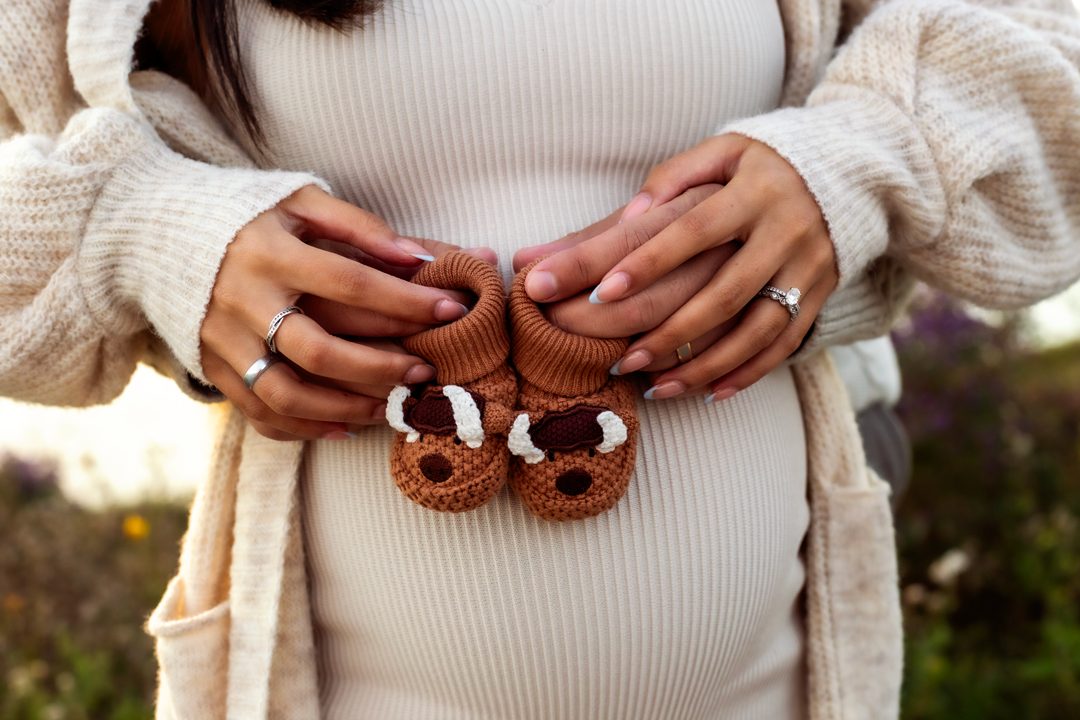 Maternity detail shot with baby booties