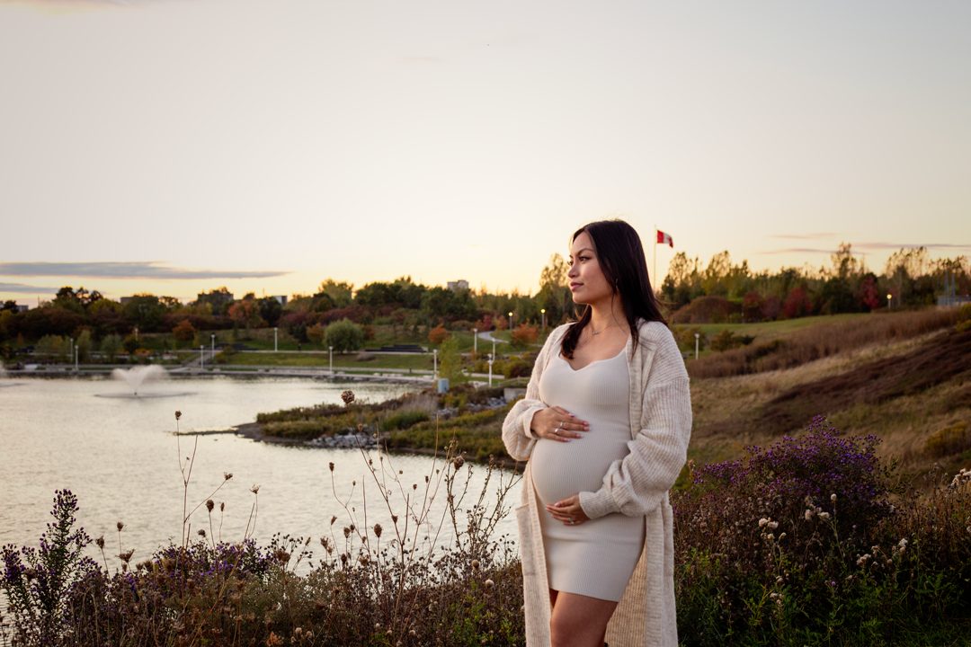 Maternity portrait by the water at sunset