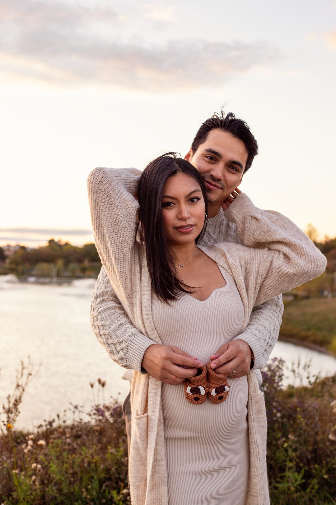 Maternity couple embracing outdoors