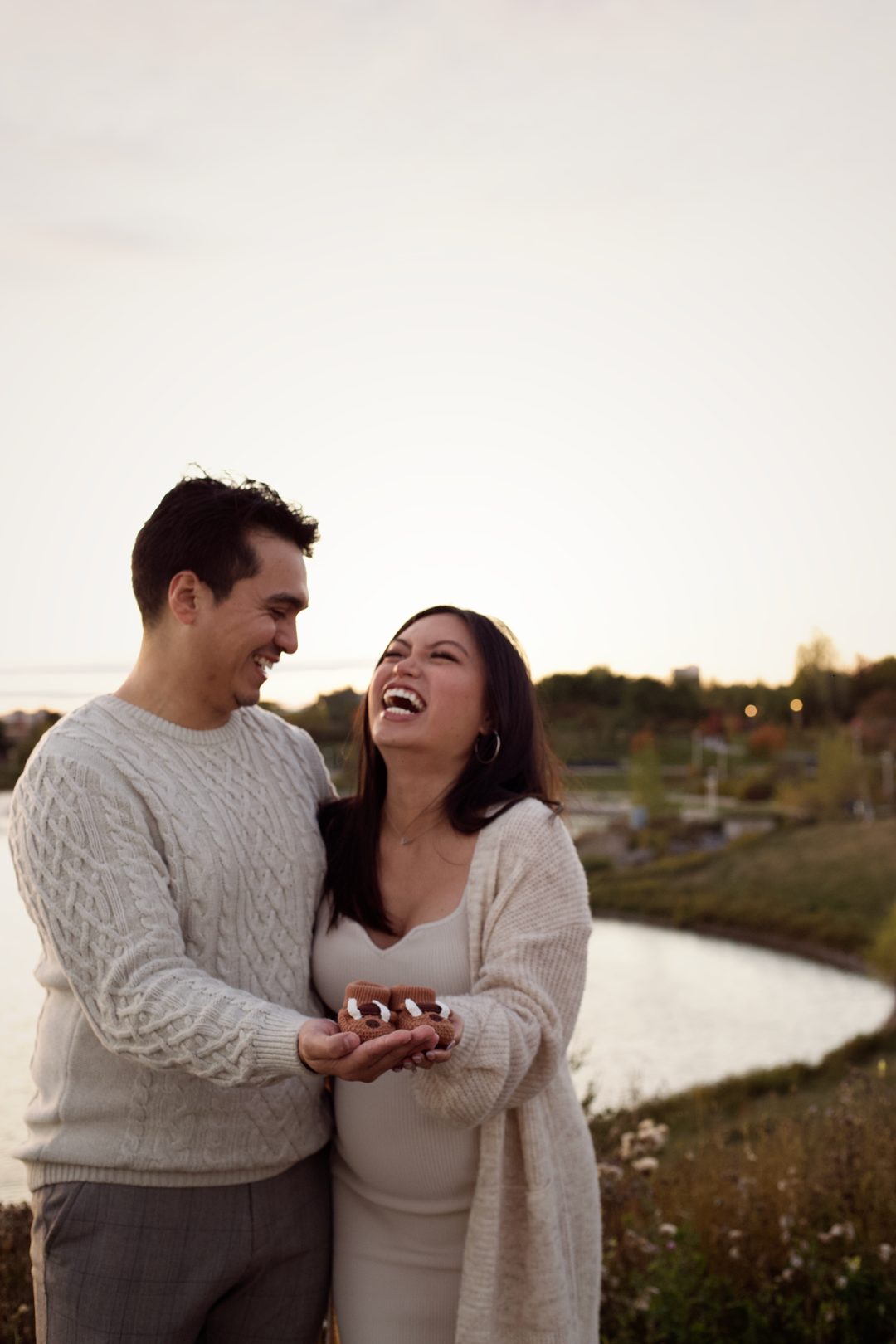 Maternity couple laughing together