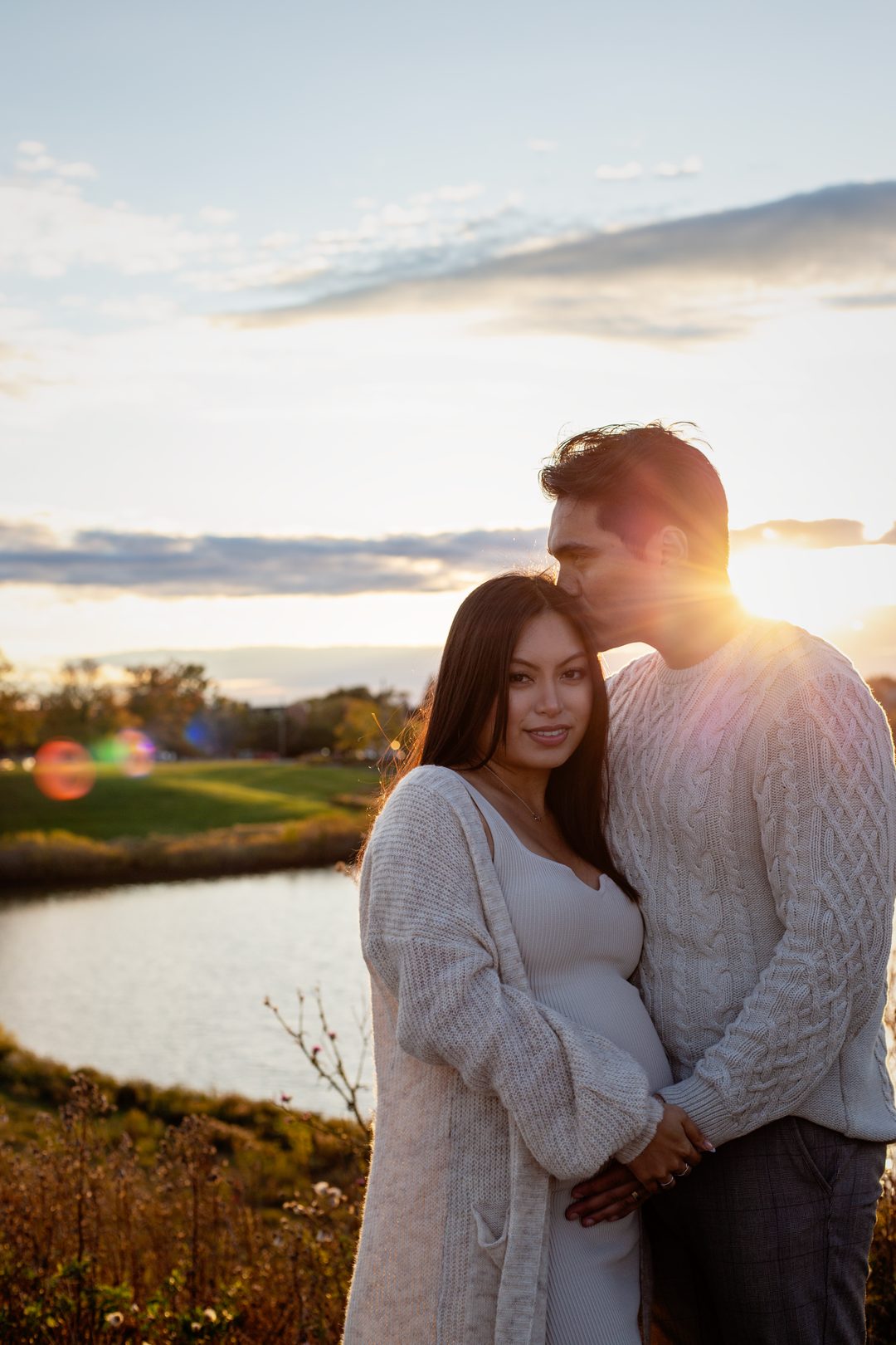 Maternity couple sunset kiss