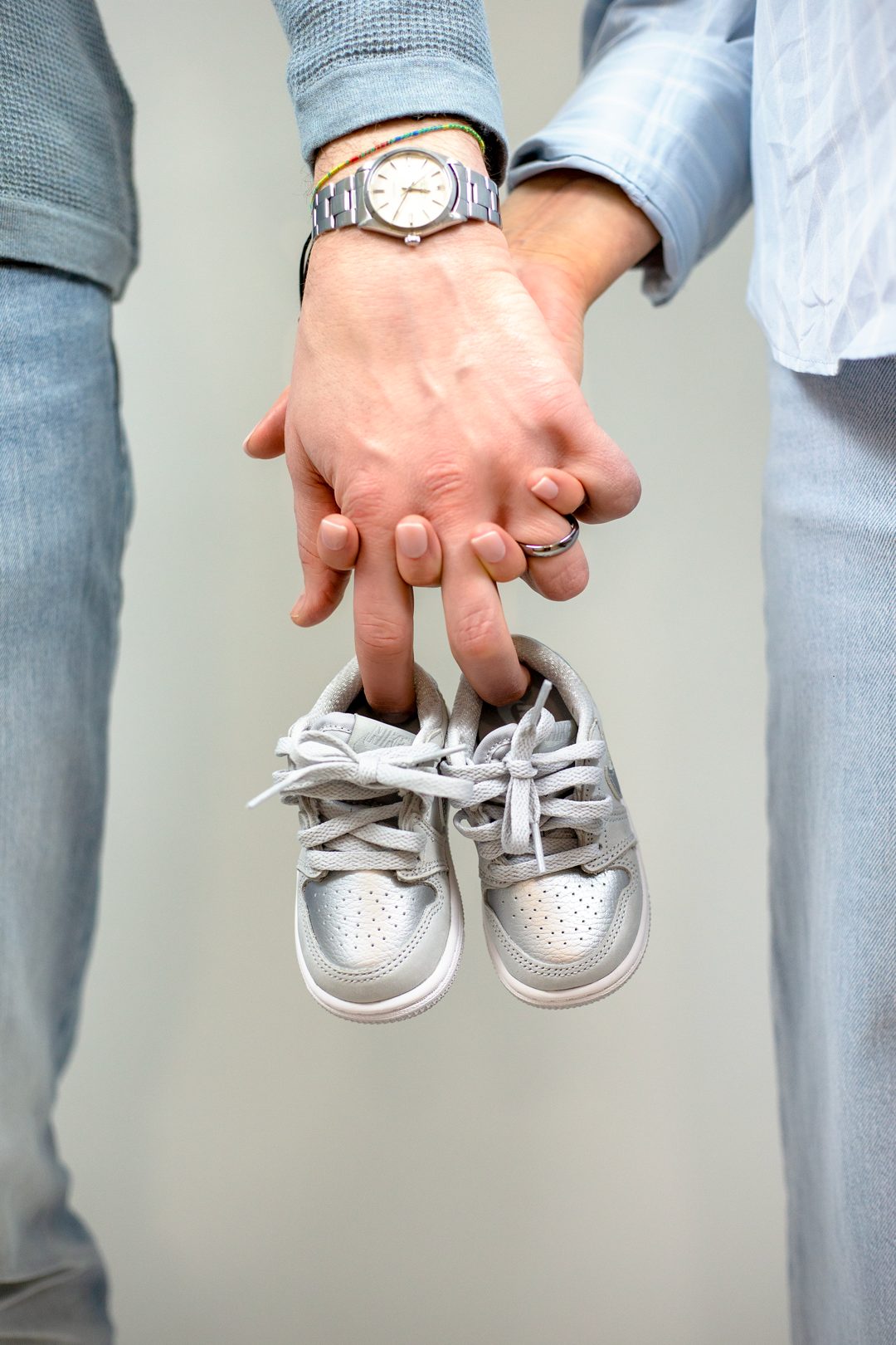 Couple holding baby sneakers