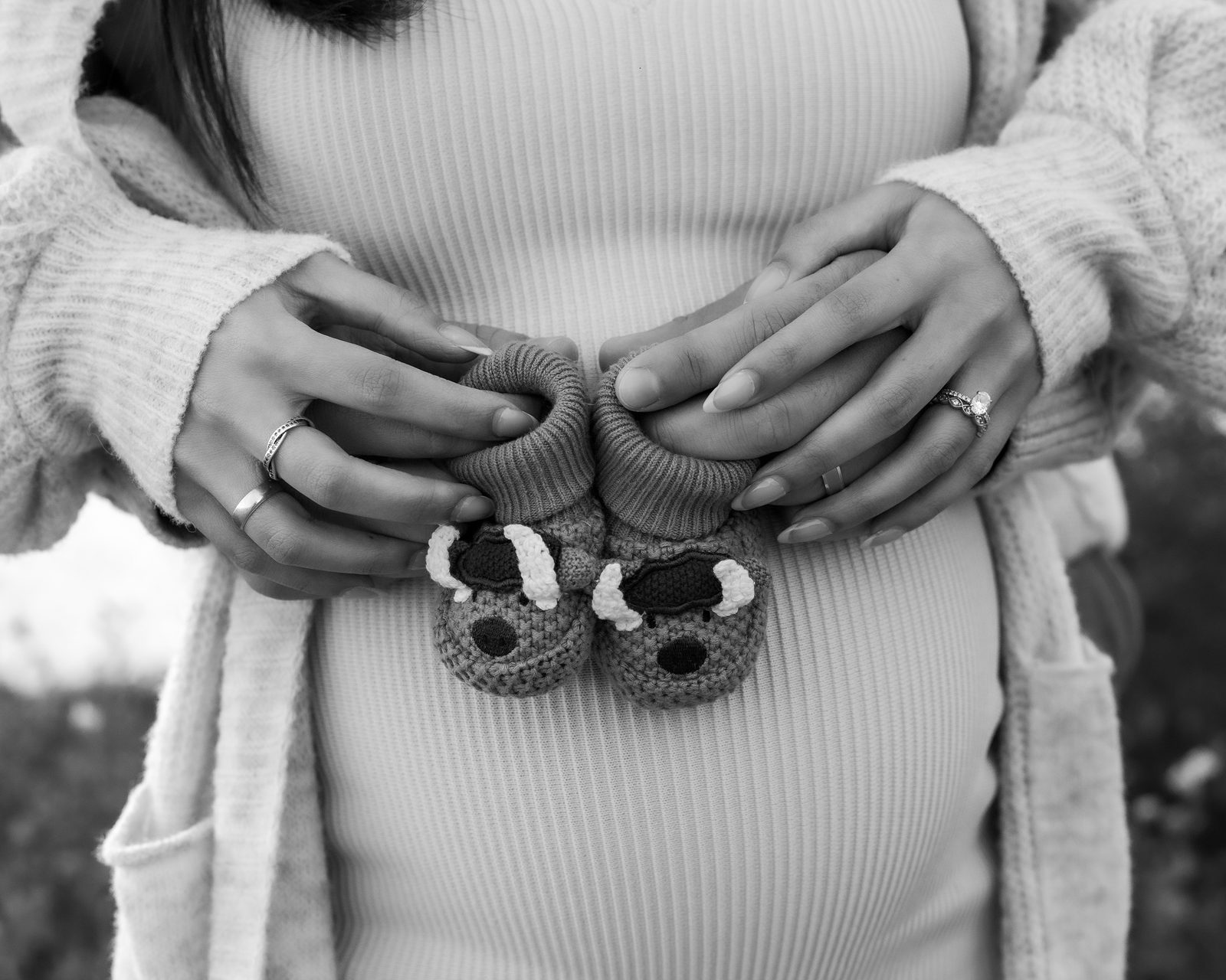 Maternity detail shot with knit booties, black and white